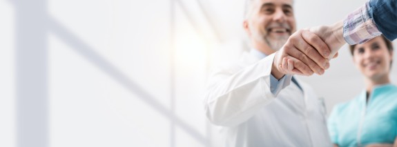 Arzt schüttelt Patient die Hand